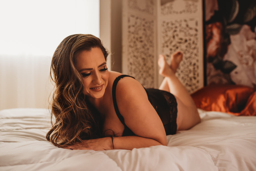 Inclusive boudoir photography pose in Cameron Park near Folsom with relaxed client on bed